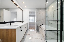 Bathroom with double vanity, light marble finish flooring, a bath, recessed lighting, and a marble finish shower - 