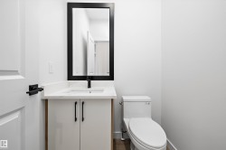 Half bath featuring vanity and toilet - 