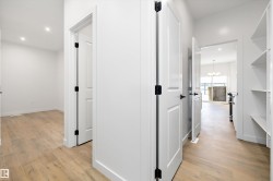 Hall with a chandelier, recessed lighting, and light wood-type flooring - 