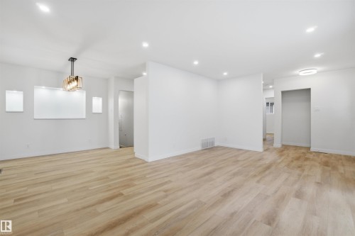 Spare room with light wood finished floors, recessed lighting, and a chandelier - 5711 95 Avenue, Edmonton, AB - Indoor Photo Showing Other Room