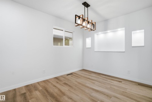 Empty room with light wood-style flooring and baseboards - 5711 95 Avenue, Edmonton, AB - Indoor Photo Showing Other Room