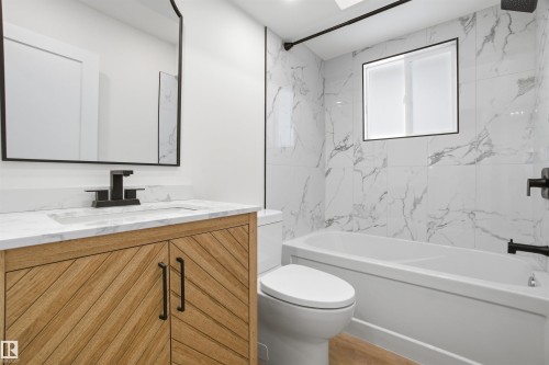 Bathroom with vanity and a combined bath / shower with marble appearance - 5711 95 Avenue, Edmonton, AB - Indoor Photo Showing Bathroom