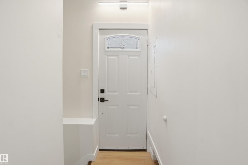 Entryway featuring wood finished floors and baseboards - 5711 95 Avenue, Edmonton, AB - Indoor Photo Showing Other Room