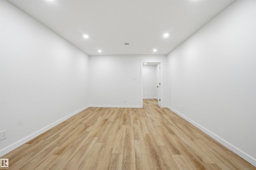 Empty room with light wood-style floors and recessed lighting - 5711 95 Avenue, Edmonton, AB - Indoor Photo Showing Other Room