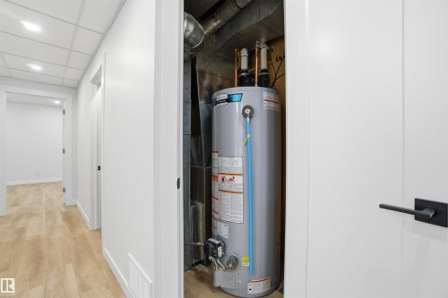 Utility room with gas water heater - 5711 95 Avenue, Edmonton, AB - Indoor Photo Showing Basement