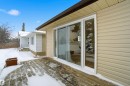 Snow covered patio featuring a wooden deck - 5711 95 Avenue, Edmonton, AB  - Outdoor With Exterior 