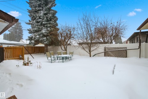 Yard layered in snow featuring a fenced backyard and outdoor dining space - 5711 95 Avenue, Edmonton, AB - Outdoor