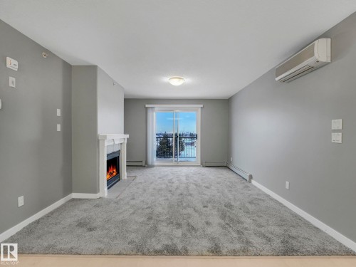 407 592 Hooke Road, Edmonton, AB - Indoor Photo Showing Other Room With Fireplace