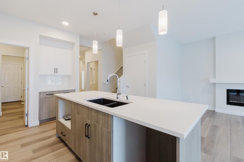 4106 67 Street, Beaumont, AB - Indoor Photo Showing Kitchen With Fireplace With Double Sink
