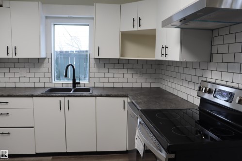 New sink and faucet - 4508 52 St., Wetaskiwin, AB - Indoor Photo Showing Kitchen With Double Sink