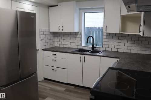 Entrance to back yard off kitchen - 4508 52 St., Wetaskiwin, AB - Indoor Photo Showing Kitchen With Double Sink