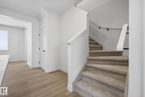 Staircase with wood finished floors and baseboards - 119 Brickyard Drive, Stony Plain, AB - Indoor Photo Showing Other Room