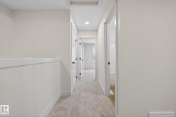 Corridor with light carpet and recessed lighting - 