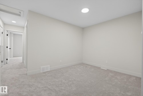 Empty room featuring carpet floors and baseboards - 119 Brickyard Drive, Stony Plain, AB - Indoor Photo Showing Other Room