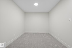 Carpeted spare room featuring baseboards - 