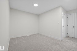 Unfurnished bedroom featuring light carpet - 