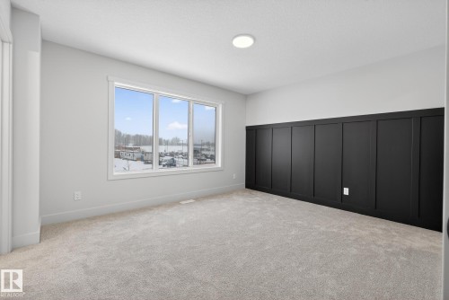 Unfurnished bedroom featuring light colored carpet and a textured ceiling - 119 Brickyard Drive, Stony Plain, AB - Indoor