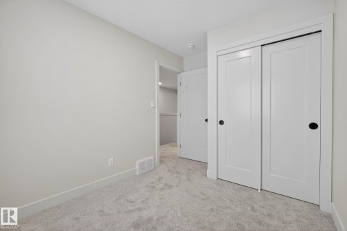 Unfurnished bedroom with light colored carpet and a closet - 119 Brickyard Drive, Stony Plain, AB - Indoor Photo Showing Other Room