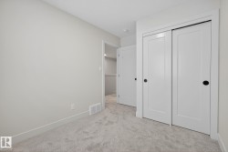 Unfurnished bedroom with light colored carpet and a closet - 