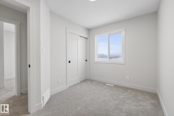 Unfurnished bedroom featuring light carpet and a closet - 