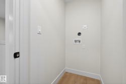 Laundry area featuring light wood-type flooring and hookup for a washing machine - 