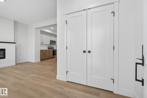View of closet - 119 Brickyard Drive, Stony Plain, AB - Indoor Photo Showing Other Room With Fireplace