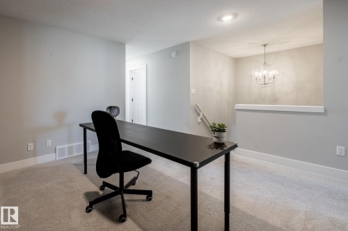 Office area with light colored carpet, a textured ceiling, and a chandelier - 1440 Darby Green, Edmonton, AB - Indoor Photo Showing Other Room