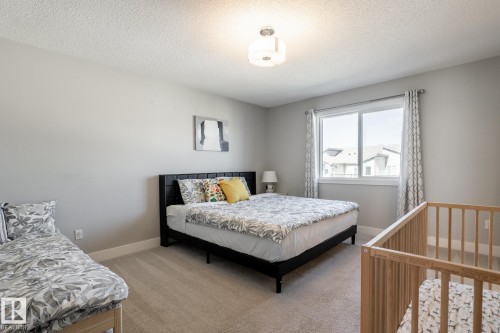 Bedroom with light carpet and a textured ceiling - 1440 Darby Green, Edmonton, AB - Indoor Photo Showing Bedroom
