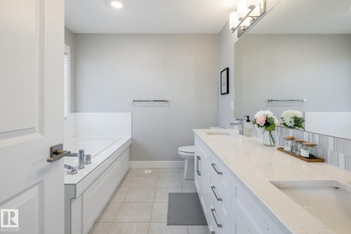 Full bathroom featuring a garden tub, double vanity, light tile patterned flooring, and recessed lighting - 1440 Darby Green, Edmonton, AB - Indoor Photo Showing Bathroom