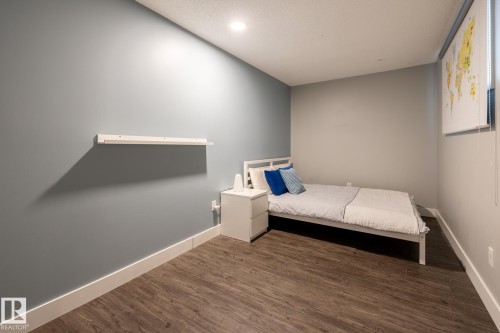 Bedroom featuring dark wood-type flooring and recessed lighting - 1440 Darby Green, Edmonton, AB - Indoor Photo Showing Bedroom