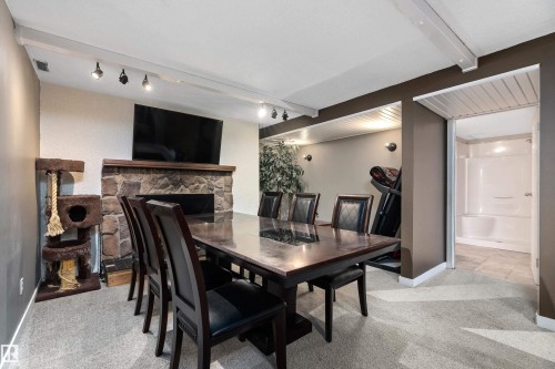 33 Wild Hay Drive, Devon, AB - Indoor Photo Showing Dining Room With Fireplace