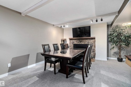 33 Wild Hay Drive, Devon, AB - Indoor Photo Showing Dining Room With Fireplace