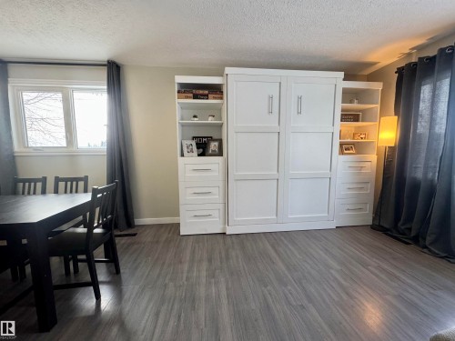 Dining area with a textured ceiling and dark wood-style flooring - 5140 52 Avenue, Ryley, AB - Indoor Photo Showing Dining Room