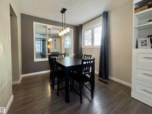 Dining room featuring healthy amount of natural light, dark wood finished floors, and a textured ceiling - 5140 52 Avenue, Ryley, AB - Indoor Photo Showing Dining Room