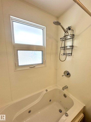 Bathroom featuring a combined bath / shower with jetted tub - 5140 52 Avenue, Ryley, AB - Indoor Photo Showing Bathroom