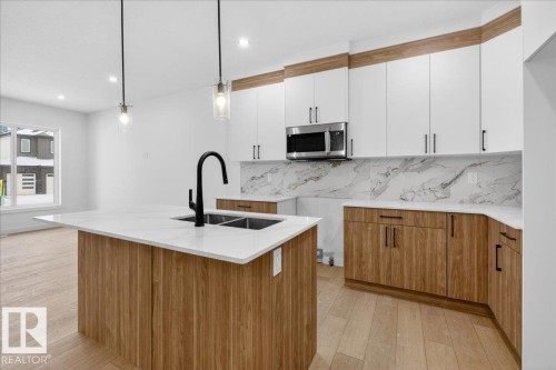 131 Creekside Lane, Leduc, AB - Indoor Photo Showing Kitchen With Double Sink With Upgraded Kitchen