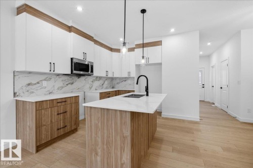 131 Creekside Lane, Leduc, AB - Indoor Photo Showing Kitchen With Double Sink With Upgraded Kitchen