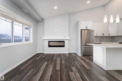 56 3305 Orchards Link Sw, Edmonton, AB - Indoor Photo Showing Kitchen With Fireplace With Upgraded Kitchen
