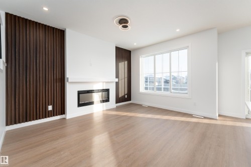 73 Elliot Wynd, Fort Saskatchewan, AB - Indoor Photo Showing Other Room With Fireplace