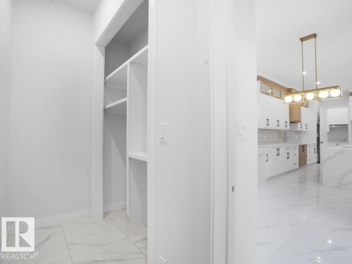 Mud Room with light marble finish flooring and baseboards - 6131 Crawford Drive, Edmonton, AB - Indoor