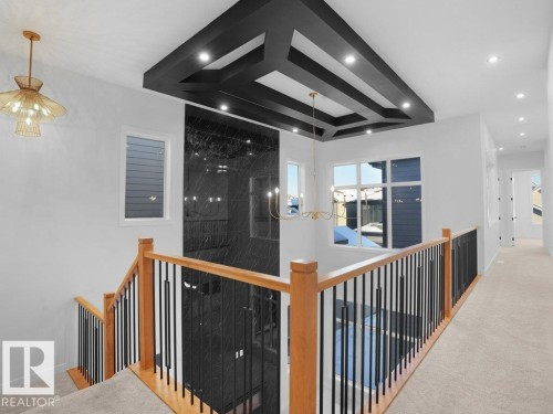 Corridor with a chandelier, carpet flooring, and an upstairs landing - 6131 Crawford Drive, Edmonton, AB - Indoor Photo Showing Other Room