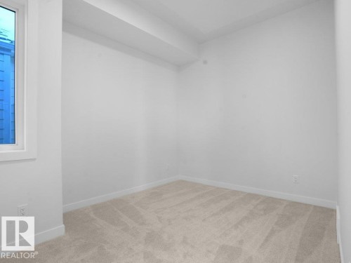 Unfurnished room featuring light colored carpet and baseboards - 6131 Crawford Drive, Edmonton, AB - Indoor Photo Showing Other Room