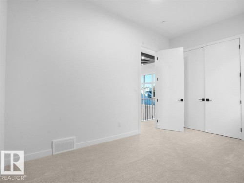 Unfurnished bedroom featuring carpet flooring and a closet - 6131 Crawford Drive, Edmonton, AB - Indoor Photo Showing Other Room
