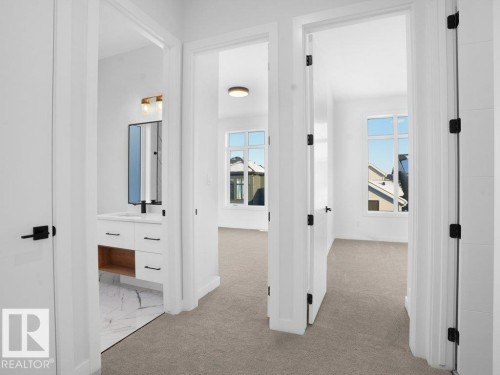 Hallway with healthy amount of natural light and light colored carpet - 6131 Crawford Drive, Edmonton, AB - Indoor Photo Showing Other Room