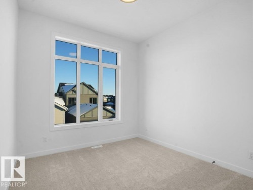 Carpeted spare room featuring baseboards - 6131 Crawford Drive, Edmonton, AB - Indoor Photo Showing Other Room