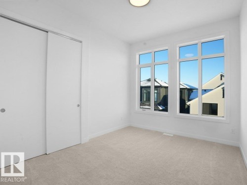 Unfurnished bedroom featuring a closet and light colored carpet - 6131 Crawford Drive, Edmonton, AB - Indoor Photo Showing Other Room