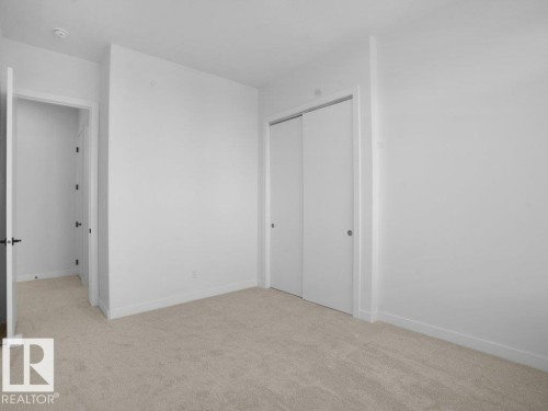 Unfurnished bedroom featuring light carpet and a closet - 6131 Crawford Drive, Edmonton, AB - Indoor Photo Showing Other Room