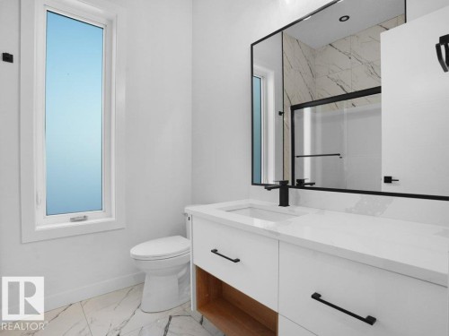 Bathroom featuring light marble finish floors, a marble finish shower, and vanity - 6131 Crawford Drive, Edmonton, AB - Indoor Photo Showing Bathroom