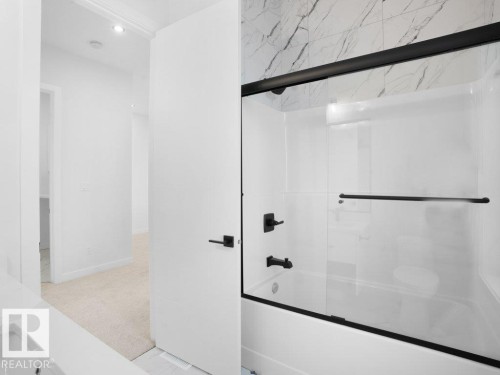 Full bathroom featuring bath / shower combo with glass door, light carpet, and vanity - 6131 Crawford Drive, Edmonton, AB - Indoor