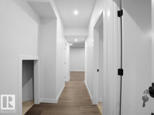 Hall featuring wood finished floors and recessed lighting - 6131 Crawford Drive, Edmonton, AB - Indoor Photo Showing Other Room